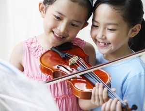 cute kids playing violin
