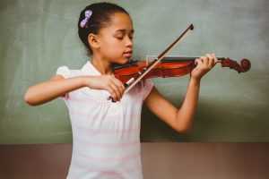 girl playing violin classromm