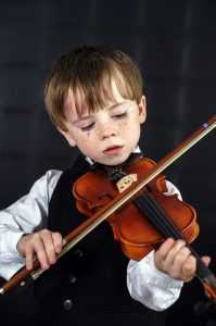 cute child playing violin
