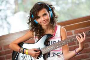 female guitarist with headphones