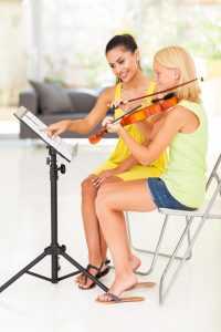 student receiving violin lesson