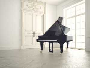 grand piano in white room isolated