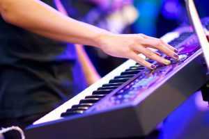 playing keyboard at rock concert