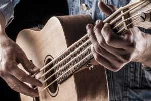 man playing bass ukulele