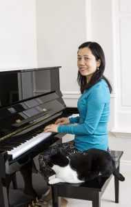 playing piano with a cat