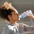 girl drinking from a water bottle