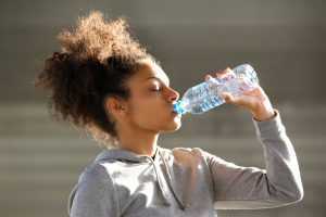 girl drinking from a water bottle