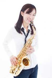 girl posing with saxophone