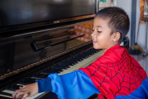 kid playing piano